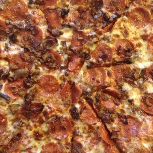 Close-up of a Mr Pizza pepperoni and sausage pizza with melted cheese.